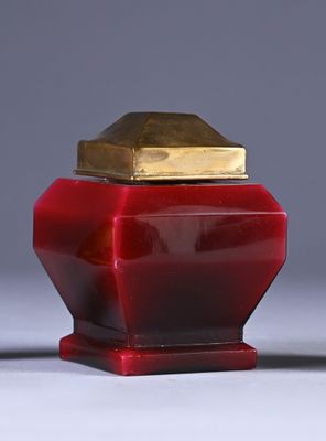 pair of red and gold vases sitting on top of a white table