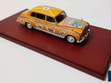 a toy car that is sitting on a red surface