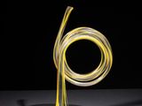 a close up of a glass sculpture on a table with a black background
