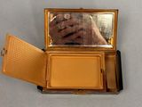 someone is taking a picture of their reflection in a compact mirror