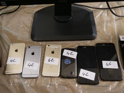 many cell phones that are sitting on a table