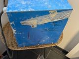 une boîte à outils bleue posée sur une chaise en osier