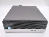 the hp desktop computer is on a white surface with a blue sticker on it