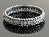 silver beaded stretch bracelets stacked on a black surface