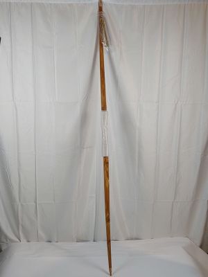 a wooden pole that is standing up against a white curtain
