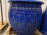 two blue vases sitting on a pallet next to each other