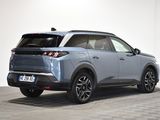 the rear end of a blue suv parked in a white room