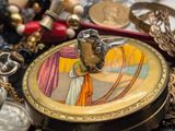 a picture of a necklace with a picture of a woman on it