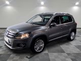 the volkswagen tiguan is parked on a checkered tile floor