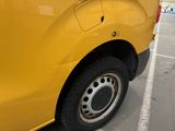 a yellow truck that is parked in a parking lot