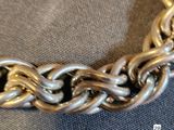 silver chain bracelet with a clasp on a gray background