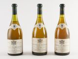 three bottles of wine sitting next to each other on a white surface