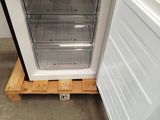 a small refrigerator with a door open on a pallet