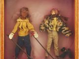 two dolls in a shadow box with a dog on a leash