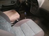 a picture of a car with a seat up and a bottle of water in the passenger seat