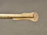 a small metal object with a long handle on it