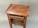 a small wooden table with a drawer underneath it