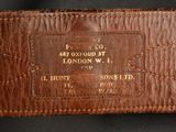 an image of a close up of a leather belt with a name tag on it