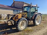 a tractor that is parked in the dirt