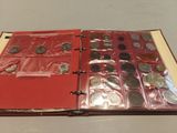 a red binder with coins in it on a table