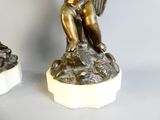 paire de figurines anciennes en bronze d'un garçon et d'une fille