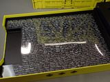a yellow box with writing on it and a cell phone in it
