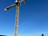 a crane that is standing in the middle of a parking lot