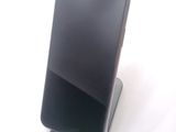 a cell phone that is sitting on top of a stand