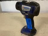 a corded drill is sitting on a table in front of a wall