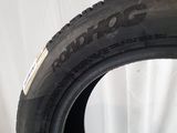 a close up of a tire on a white surface with a white curtain in the background