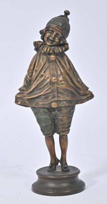 bronze figurine of a boy with a hat on his head