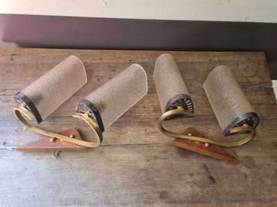 three rolls of toilet paper and a pair of scissors on a wooden table