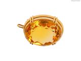 a close up of a yellow topaz stone in a gold plated setting