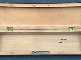a small wooden box with a metal latch on it