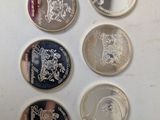 six different british coins on a white surface with a white background