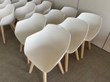 many white chairs lined up in a row on the floor