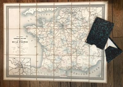 a map of france on the wall next to a wallet