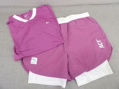 purple and white shorts with white letters on them on a couch