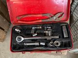 a red tool box with tools in it on the floor