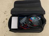 a black case with wires and a charger inside of it