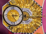 a clock that is sitting on a table with a chain around it