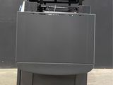 the printer is sitting on top of a pallet in a warehouse