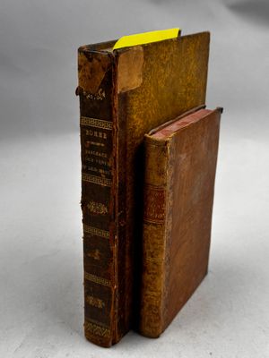 deux vieux livres posés l'un sur l'autre sur une table