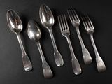 six silver spoons and a fork on a black surface