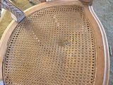 an image of a wooden chair with a wicker seat and back rest