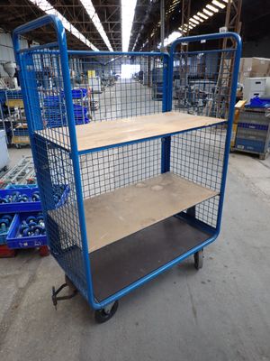 blue wire mesh shelf cart with wooden shelves in a warehouse