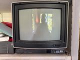 a small television sitting on top of a book shelf
