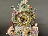 a figurine of a woman sitting on top of a clock