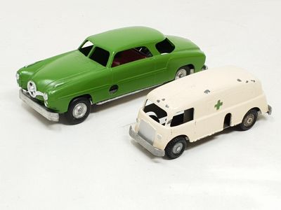 two toy cars sitting next to each other on a white surface