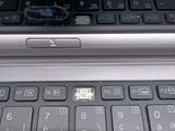 a close up of a laptop keyboard with a small hole in the keyboard